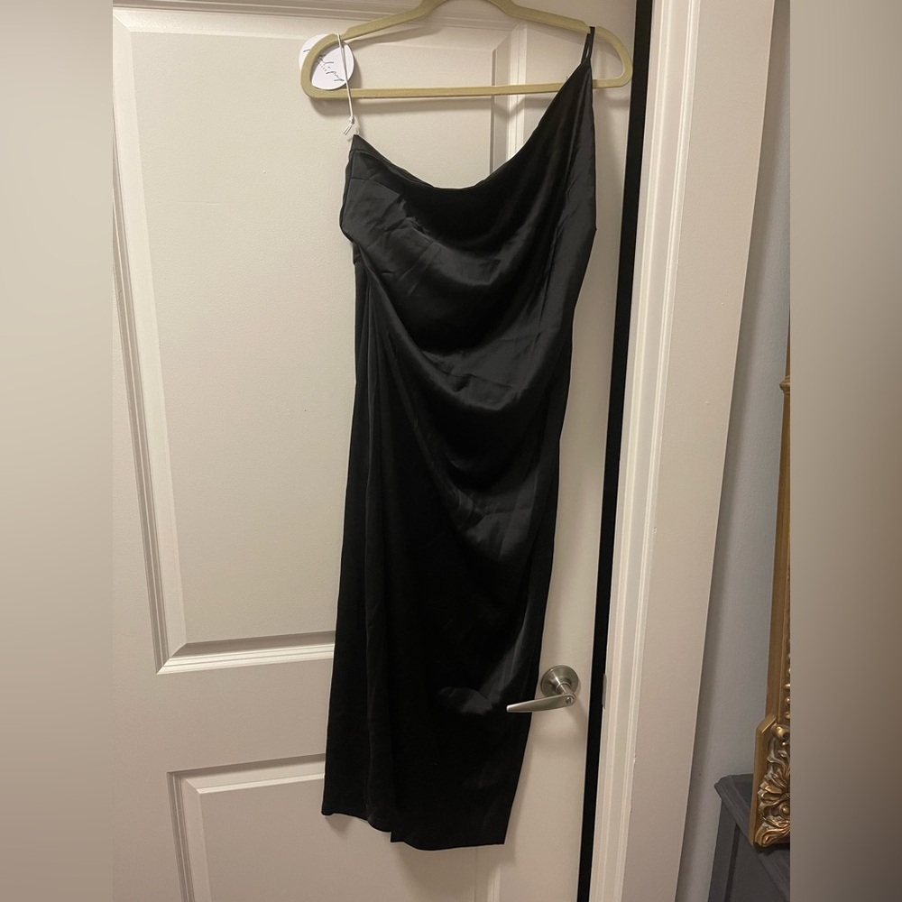 One shoulder black satin slip dress.